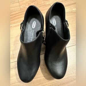 Black leather wedge heel bootie.